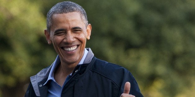 US President Barack Obama gives a thumbs-up as he walks from Marine One upon arrival on the South Lawn of the White House in Washington, DC, July 26, 2013, after returning from Camp David where he attended a retreat with members of his Cabinet. AFP PHOTO / Saul LOEB (Photo credit should read SAUL LOEB/AFP/Getty Images)