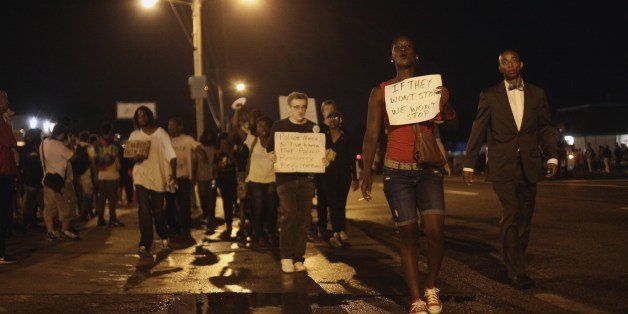 Demonstrators protest the shooting death of Michael Brown August 20, 2014 in Ferguson, Missouri. St. Louis County Prosecutor Bob McCullough has not filed any charges against Ferguson Police Officer Darren Wilson, after Wilson fatally wounded Brown August 9th. AFP PHOTO/Joshua LOTT (Photo credit should read Joshua LOTT/AFP/Getty Images)