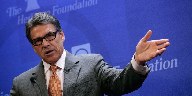 WASHINGTON, DC - AUGUST 21: Texas Governor Rick Perry participates in a panel discussion about immigration and the crisis along the Texas-Mexico border at the conservative think tank The Heritage Foundation August 21, 2014 in Washington, DC. The governor of Texas since 2000 and a one-time presidential candidate, Perry was recently indicted by a Travis County grand jury for abuse of power and coercion of a public servant after he vetoed $7.5 million in funding for the state's Public Integrity Unit, which is investigating Perry's Cancer Prevention and Research Institute of Texas. (Photo by Chip Somodevilla/Getty Images)