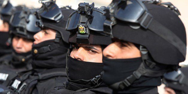 An Iraqi member of the Special Weapons and Tactics team (SWAT) looks on during a ceremony marking Iraqi police forces 92nd anniversary in the capital Baghdad on January 9, 2014. The ceremony takes place as fighting between Iraqi security forces and militants rage in Iraq's Anbar province. AFP PHOTO / AHMAD AL-RUBAYE (Photo credit should read AHMAD AL-RUBAYE/AFP/Getty Images)