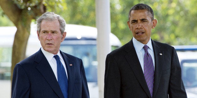 US President Barack Obama (R) and former US President George W. Bush arrive on July 2, 2013 for a wreath-laying ceremony for victims of the 1998 Embassy bombing at the Bombing Memorial at the US Embassy in Dar Es Salaam. Bush is in Tanzania for a forum of regional First Ladies, hosted by his wife Laura, which will also be attended by First Lady Michelle Obama.AFP PHOTO / Saul LOEB (Photo credit should read SAUL LOEB/AFP/Getty Images)