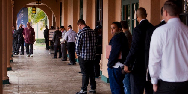 Job seekers line up for the Recruit Military veteran job fair in San Diego, California, U.S., on Thursday, Feb. 27, 2014. More Americans than forecast filed applications for unemployment benefits last week, a sign the labor market is improving in fits and starts. Photographer: Sam Hodgson/Bloomberg via Getty Images