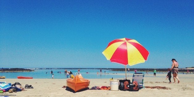 People enjoying the beach on hot summer day