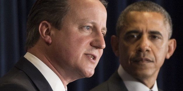 US President Barack Obama (R) and British Prime Minister David Cameron hold a joint press conference during the G7 Summit at the European Council in Brussels, on June 5, 2014. Leaders of the Group of Seven industrialised nations head from a two-day summit in Brussels to Paris before travelling to D-Day commemorations in Normandy on June 6 where they will rub shoulders with the Russian leader. AFP PHOTO / SAUL LOEB (Photo credit should read SAUL LOEB/AFP/Getty Images)