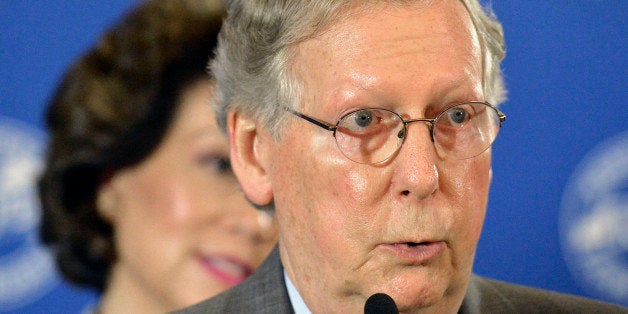 Kentucky Republican Senator Mitch McConnell responds to a question from reporters following a candidates forum at the Kentucky Farm Bureau Insurance headquarters, Wednesday, Aug. 20, 2014, in Louisville, Ky. (AP Photo/Timothy D. Easley)