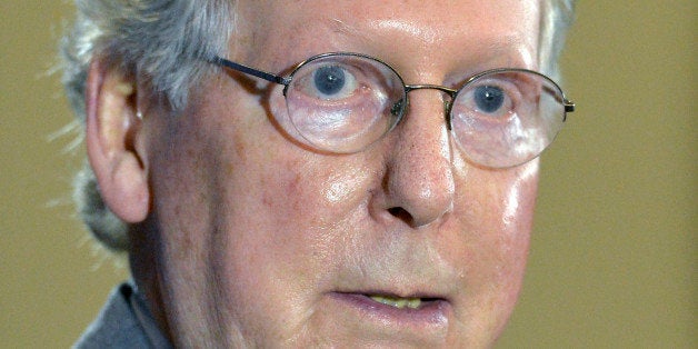 Kentucky Republican Senator Mitch McConnell responds to a question from reporters following a candidates forum at the Kentucky Farm Bureau Insurance headquarters, Wednesday, Aug. 20, 2014, in Louisville, Ky. (AP Photo/Timothy D. Easley)