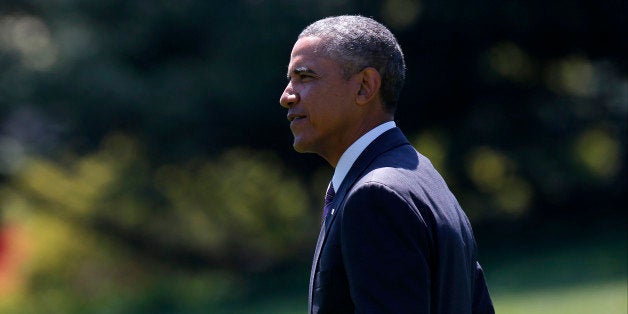 President Barack Obama walks on the South Lawn of the White House in Washington, Friday, Aug. 29, 2014, as he travels to West