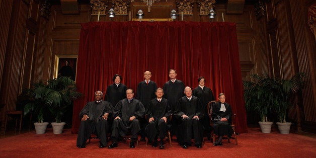 WASHINGTON - OCTOBER 08: U.S. Supreme Court members (first row L-R) Associate Justice Clarence Thomas, Associate Justice Antonin Scalia, Chief Justice John Roberts, Associate Justice Anthony Kennedy, Associate Justice Ruth Bader Ginsburg, (back row L-R) Associate Justice Sonia Sotomayor, Associate Justice Stephen Breyer, Associate Justice Samuel Alito and Associate Justice Elena Kagan pose for photographs in the East Conference Room at the Supreme Court building October 8, 2010 in Washington, DC. This is the first time in history that three women are simultaneously serving on the court. (Photo by Chip Somodevilla/Getty Images)