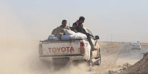 MOSUL, IRAQ - AUGUST 26: August 25, 2014 dated pictures show Peshmerga forces' ongoing progression to fight against army forces led by Islamic State (IS) and seize to regain areas in Mosul. Peshmerga forces patrol the area in Al-Bakir neighborhood of Mosul, Iraq on August 25, 2014. (Photo by Ensar Ozdemir/Anadolu Agency/Getty Images)