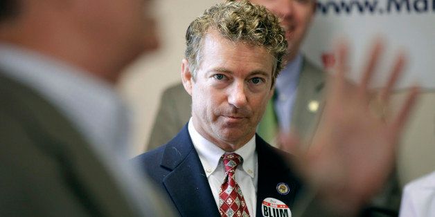 Sen. Rand Paul, R-Ky. listens he is introduced to speak by Iowa Republican congressional candidate Rod Blum, left, during a meeting with local Republicans, Tuesday, Aug. 5, 2014, in Hiawatha, Iowa. (AP Photo/Charlie Neibergall)