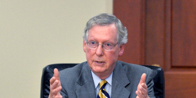 Kentucky Republican Senator Mitch McConnell answers a question from the board of Kentucky Farm Bureau insurance during a candidates forum at the Kentucky Farm Bureau Insurance headquarters, Wednesday, Aug. 20, 2014, in Louisville, Ky. (AP Photo/Timothy D. Easley)