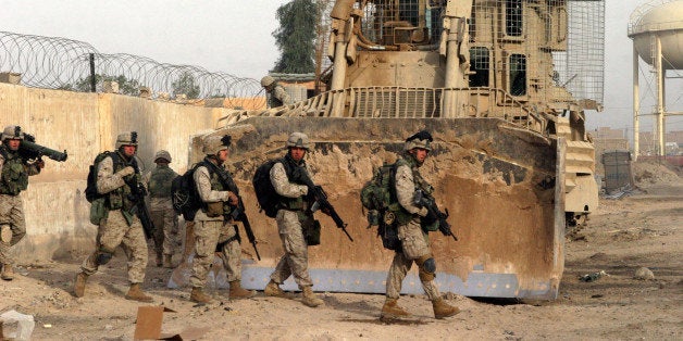 In this photo released by the US Marines, Marines of Bravo Company, 1st Battalion, 8th Marines set out on a patrol while participating in Deer Drive, part of Operation Al Fajr, clearing the city of Fallujah, Iraq, of insurgent activity and weapons caches. Picture was taken on Nov. 26 2004. (AP Photo/USMC, SSgt. Jonathan C. Knauth )