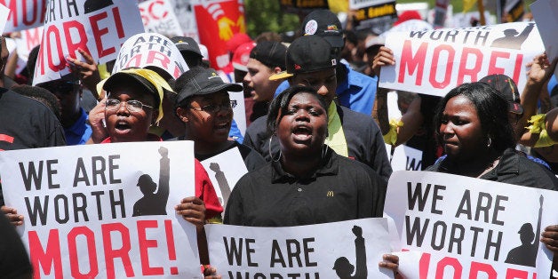 OAK BROOK, IL - MAY 21: Fast food workers and activists demonstrate outside the McDonald's corporate campus on May 21, 2014 in Oak Brook, Illinois. The demonstrators were calling on McDonald's to pay a minimum wage of $15-per-hour and offer better working conditions for their employees. Several protestors were arrested after they entered and ignored police orders to leave the McDonald's campus. McDonald's is scheduled to hold its annual shareholder's meeting tomorrow at the campus. (Photo by Scott Olson/Getty Images)