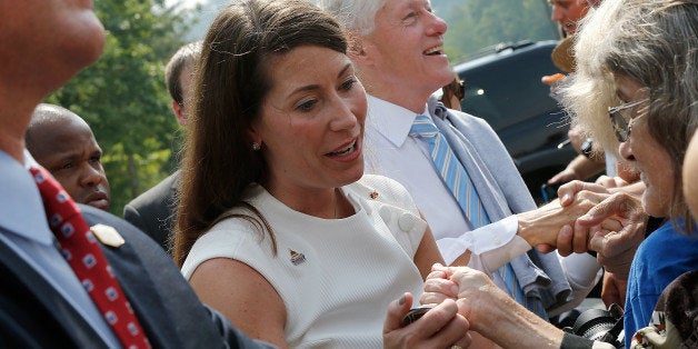 HAZARD, KY - AUGUST 06: U.S. Senate Democratic candidate and Kentucky Secretary of State Alison Lundergan Grimes greets supporters while campaigning with former U.S. President Bill Clinton at an event where they addressed members of the United Mine Workers of America August 6, 2014 in Hazard, Kentucky. Grimes recently received the endorsement of the UMWA and a recent 'Bluegrass Poll' by the Louisville Courier-Journal shows Grimes in a virtual tie with the incumbent, Senate Republican Leader Mitch McConnell (R-KY). (Photo by Win McNamee/Getty Images)