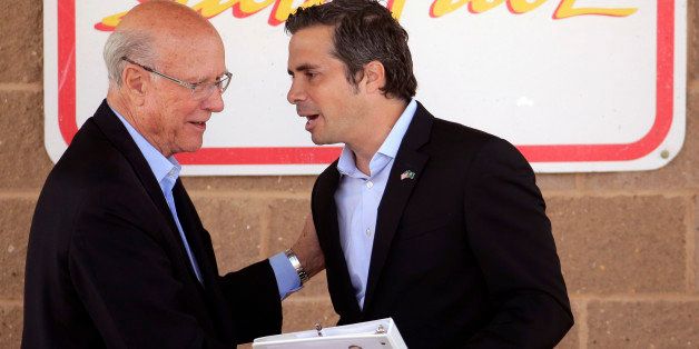 Republican Sen. Pat Roberts, left, and independent candidate Greg Orman talk after a debate at the Kansas State Fair Saturday, Sept. 6, 2014, in Hutchinson, Kan. (AP Photo/Charlie Riedel)