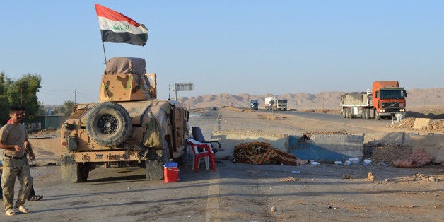 SALADIN, IRAQ - SEPTEMBER 07: Lorries and a tank are on the Kirkuk - Baghdad road in Suleiman Bey, town of Tuz Khurmato, Iraq