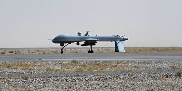 FILE - In this June 13, 2010, file photo a U.S. Predator unmanned drone armed with a missile stands on the tarmac of Kandahar military airport in Afghanistan. Hunting al-Qaida targets from Pakistan to Afghanistan, Yemen to Somalia, the fleet of U.S. armed Predator and Reaper drones that killed two American members of al-Qaida in Yemen Friday, Sept. 30, 2011, are the night stalkers of the expanded U.S. war on terrorists. (AP Photo/Massoud Hossaini, Pool, File)