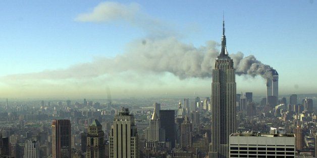 Plumes of smoke pour from the World Trade Center buildings in New York Tuesday, Sept. 11, 2001. Planes crashed into the upper floors of both World Trade Center towers minutes apart Tuesday in a horrific scene of explosions and fires that left gaping holes in the 110-story buildings. (AP Photo/Patrick Sison)
