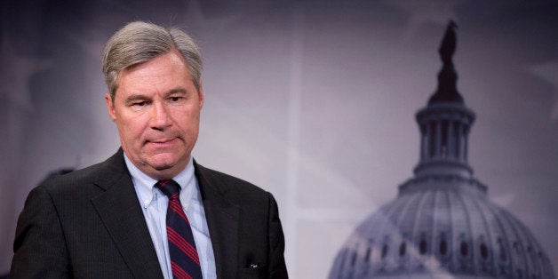 Sen. Sheldon Whitehouse, D-R.I. listens to reporter's question during a news conference on Capitol Hill in Washington, Wednes