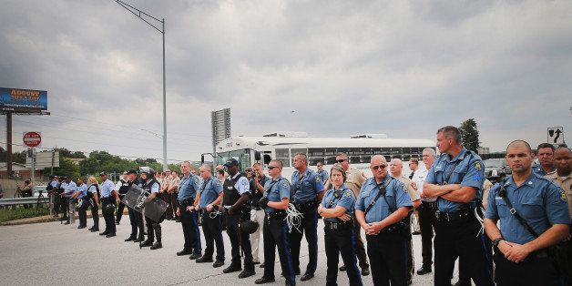 FERGUSON, MO - SEPTEMBER 10: Police block demonstrators from gaining access to Interstate Highway 70 on September 10, 2014 near Ferguson, Missouri. The demonstrators had planned to shut down I70 but their efforts were thwarted by a large contingent of police from several area police departments. Ferguson, in suburban St. Louis, is recovering from nearly two weeks of violent protests that erupted after teenager Michael Brown was shot and killed by Ferguson police officer Darren Wilson last month. (Photo by Scott Olson/Getty Images)