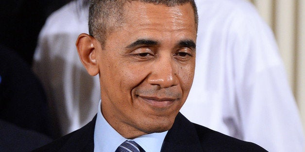 US President Barack Obama smiles before speaking on his My Brothers Keeper initiative in the East Room at the White House on