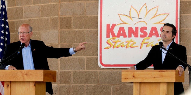 Republican Sen. Pat Roberts, left, answers a question while independent candidate Greg Orman listens during a debate at the Kansas State Fair Saturday, Sept. 6, 2014, in Hutchinson, Kan. (AP Photo/Charlie Riedel)