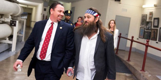 UNITED STATES - JANUARY 28: Rep. Vance McAllister, R-La., left, and his guest Willie Robertson of Duck Dynasty, walk through Cannon Tunnel after President Obama's State of the Union address in the Capitol. (Photo By Tom Williams/CQ Roll Call)