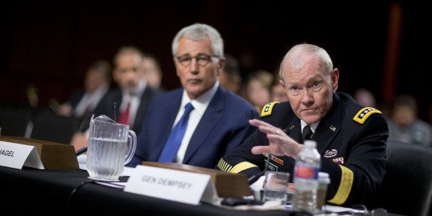 General Martin Dempsey, chairman of the Joint Chiefs of Staff, right, speaks during a Senate Armed Services Committee hearing with Chuck Hagel, U.S. secretary of defense, in Washington, D.C., U.S., on Tuesday, Sept. 16, 2014. The House majority leader said he anticipates bipartisan support for a measure granting President Barack Obama's request to arm and equip Syrian rebels under an approach that lets skeptical lawmakers register their concerns. Under the plan, the Defense Department and State Department would be required to report to Congress 15 days before putting its proposal into effect and demonstrate how it would work. Photographer: Andrew Harrer/Bloomberg via Getty Images 