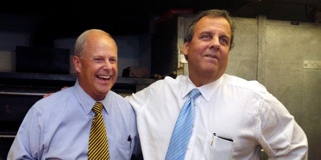 New Jersey Gov. Chris Christie, right, puts his arm around Republican gubernatorial hopeful Walt Havenstein during a campaign event at Crosby's Bakery in Nashua, N.H., Wednesday, Sept. 17, 2014. Christie has been crisscrossing the country to bolster fellow Republicans as chair of the Republicans Governors Association, with a schedule that also has included key states on the presidential nomination calendar as he considers a run in 2016. (AP Photo/Elise Amendola)
