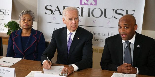 Denver Mayor Michael Hancock, right, introduces Vice President Joseph Biden, center, as Rose Andom, left, of the Rose Andom Center, looks on during a round table discussion on fighting domestic violence, at Safehouse Denver, Friday, Sept. 19, 2014. Biden visited Safehouse Denver as part of his ongoing recognition that 2014 marks 20 years since the passage of the Violence Against Women Act, which then-senator Biden introduced as a bill in 1990. (AP Photo/Brennan Linsley)