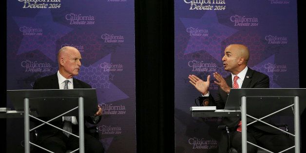 Gov. JerryÂ Brown, left, listens as Republican challenger Neel Kashkari speaks during a gubernatorial debate in Sacramento, Calif., Thursday, Sept. 4, 2014. Thursday's debate is likely to be the only one of the general election. (AP Photo/Rich Pedroncelli, Pool)
