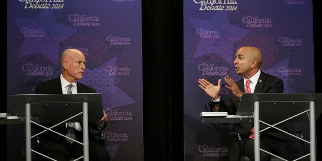 Gov. Jerry Brown, left, listens as Republican challenger Neel Kashkari speaks during a gubernatorial debate in Sacramento, C