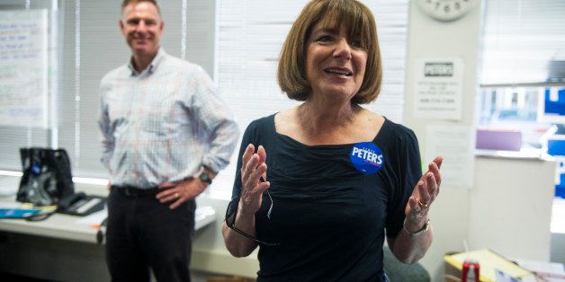UNITED STATES - OCTOBER 13: Scott Peters,left, Democratic candidate for California's 52nd Congressional district, listens as Rep. Susan Davis, D-Calif., speaks campaign workers at his campaign headquarters as supporters prepare to canvas the precinct in San Diego, Calif., on Saturday, Oct. 13, 2012. Peters is running against Rep. Brian Bilbray, R-Calif. (Photo By Bill Clark/CQ Roll Call)