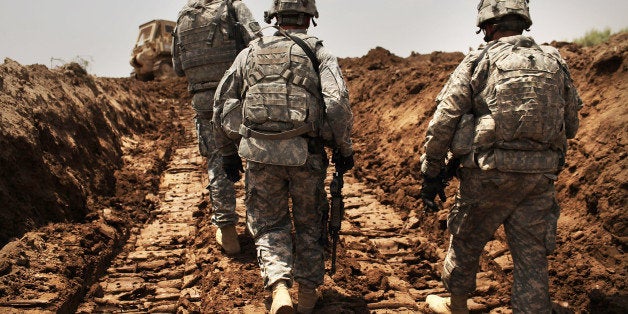 ISKANDARIYA, IRAQ - JULY 19: U.S. soldiers with the 3rd Armored Cavalry Regiment patrol a new ditch they have dug to protect the base from attack on July 19, 2011 in Iskandariya, Babil Province Iraq. As the deadline for the departure of the remaining American forces in Iraq approaches, Iraqi politicians have agreed to meet in two weeks time in order to give a final decision about extending the U.S. troops' presence beyond the end of the 2011 deadline. Violence against foreign troops has recently picked-up with June being the worst month in combat-related deaths for the military in Iraq in more than two years. Currently about 46,000 U.S. soldiers remain in Iraq. (Photo by Spencer Platt/Getty Images)