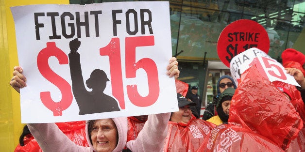 CHICAGO, IL - MAY 15: Fast food workers and activists demonstrate outside McDonald's downtown flagship restaurant on May 15, 2014 in Chicago, Illinois. The demonstration was one of several nationwide calling for wages of $15 per hour and better working conditions for fast food workers. (Photo by Scott Olson/Getty Images)