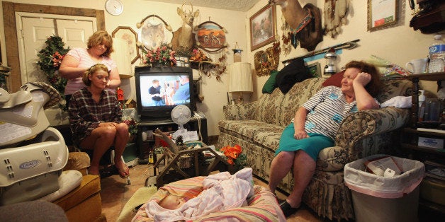 BOONEVILLE, KY - APRIL 21: Drucilla Smith (LOWER L) has her hair done as she prepares for the Owsley County High School prom in her home with sister Linda Hall (TOP L), Layla Johnson (BOTTOM C) and mother Bonnie Smith (R) in Owsley County on April 21, 2012 in Booneville, Kentucky. Daniel Boone once camped in the Appalachian mountain hamlet of Owsley County which remains mostly populated by descendants of settlers to this day. The 2010 U.S. Census listed Owsley County as having the lowest median household income in the country outside of Puerto Rico, with 41.5% of residents living below the poverty line. Familial and community bonds run deep, with a populace that shares a collective historical and cultural legacy uncommon in most parts of the country. However, the community of around 5,000 struggles with a lack of jobs due to the decline in coal, tobacco and lumber industries along with health issues including drug addiction without effective treatment. (Photo by Mario Tama/Getty Images)