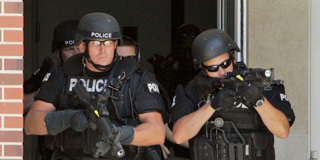 Police officers from the Omaha Emergency Response Unit look for a possible "Active Shooter" during a training exercise on the campus of the University of Nebraska at Omaha, in Omaha, Neb., Wednesday, July 11, 2007. (AP Photo/Nati Harnik)