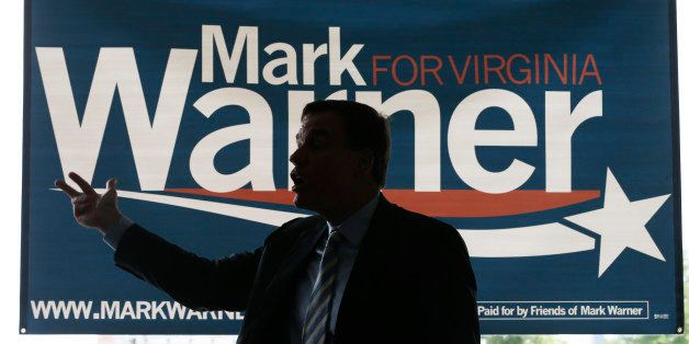 US Senator Mark Warner, D-Va., gestures as he addresses a crowd during a his campaign kickoff tour in Richmond, Va., Thursday, May 29, 2014. (AP Photo/Steve Helber)