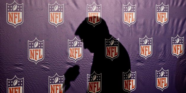 The shadow of NFL Commissioner Roger Goodell is cast on the NFL logo background as he pauses before answering a question from the media during a news conference at the annual NFL football meetings at the Arizona Biltmore, Wednesday, March 20, 2013, in Phoenix. (AP Photo/Ross D. Franklin)