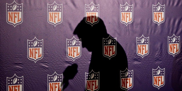 The shadow of NFL Commissioner Roger Goodell is cast on the NFL logo background as he pauses before answering a question from the media during a news conference at the annual NFL football meetings at the Arizona Biltmore, Wednesday, March 20, 2013, in Phoenix. (AP Photo/Ross D. Franklin)