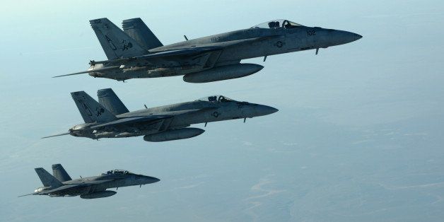 In this Tuesday, Sept. 23, 2014 photo released by the U.S. Air Force, a formation of U.S. Navy F-18E Super Hornets leaves after receiving fuel from a KC-135 Stratotanker over northern Iraq, as part of U.S. led coalition airstrikes on the Islamic State group and other targets in Syria. U.S.-led airstrikes targeted Syrian oil installations held by the militant Islamic State group overnight and early Thursday, Sept. 25, 2014, killing nearly 20 people as the militants released dozens of detainees in their de facto capital, fearing further raids, activists said. (AP Photo/U.S. Air Force, Staff Sgt. Shawn Nickel)