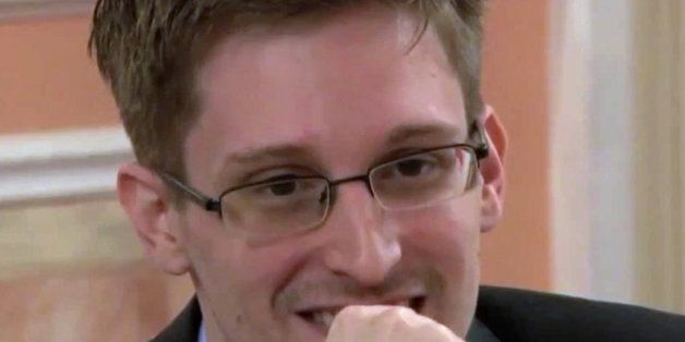 In this image made from video released by WikiLeaks on Friday, Oct. 11, 2013, former National Security Agency systems analyst Edward Snowden smiles during a presentation ceremony for the Sam Adams Award in Moscow, Russia. Snowden was awarded the Sam Adams Award, according to videos released by the organization WikiLeaks. The award ceremony was attended by three previous recipients. Snowden, who is charged by a U.S. court with violating the Espionage Act for disclosing the classified NSA programs, has been granted asylum in Russia. (AP Photo)