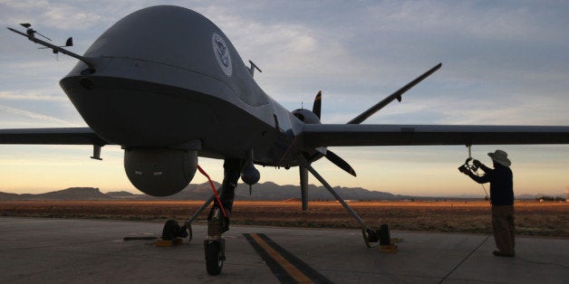 SIERRA VISTA, AZ - MARCH 07: Maintenence personel check a Predator drone operated by U.S. Office of Air and Marine (OAM), before its surveillance flight near the Mexican border on March 7, 2013 from Fort Huachuca in Sierra Vista, Arizona. The OAM, which is part of U.S. Customs and Border Protection, flies the unmanned - and unarmed - MQ-9 Predator B aircraft an average of 12 hours per day at around 19,000 feet over southern Arizona. The drones, piloted from the ground, search for drug smugglers and immigrants crossing illegally from Mexico into the United States. Due to federal sequestration cuts, Customs and Border Protection is expected to lose $500 million from its budget, and OAM staff at Ft. Huachuca are now taking unpaid furlough days once every two weeks. (Photo by John Moore/Getty Images)