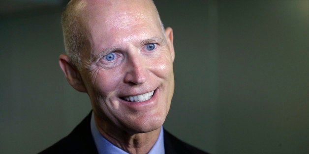 Florida Gov. Rick Scott speaks with members of the media, Monday, Sept. 22, 2014 at the University of Miami Miller School of Medicine, in Miami. (AP Photo/Wilfredo Lee)