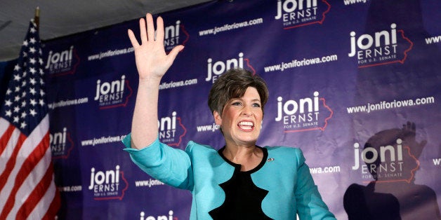 State Sen. Joni Ernst waves to supporters at a primary election night rally after winning the Republican nomination for the U
