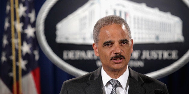 WASHINGTON, DC - AUGUST 21: Attorney General Eric Holder makes a separated statement on the unrest after the unarmed 18-year-old Michael Brown was shot by a police officer in Ferguson, Missouri, during a major financial fraud announcement press conference August 21, 2014 at the Justice Department in Washington, DC. Holder spoke on the current situation in Ferguson one day after his visit to the town and met with Browns family, saying the investigation of the shooting will be thorough and will be fair, and Department of Justice stands with the people of Ferguson. (Photo by Alex Wong/Getty Images)