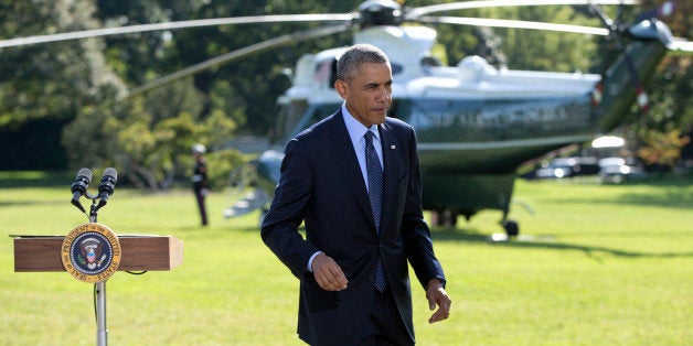 President Barack Obama walks from the podium after speaking about the participation of five Arab nations in airstrikes against militants in Syria., Tuesday, Sept. 23, 2014, on the South Lawn the White House, in Washington. The president said the participation of five Arab nations in airstrikes against militants in Syria "makes it clear to the world this is not America's fight alone." Afterward he and first lady Michelle Obama boarded Marine One for a short trip to Andrews Air Force Base, Md., then onto New York and the United Nations. (AP Photo/Carolyn Kaster)