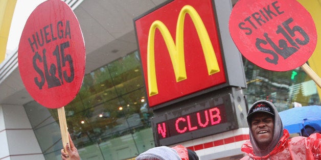 CHICAGO, IL - MAY 15: Fast food workers and activists demonstrate outside McDonald's downtown flagship restaurant on May 15,