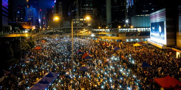 HONG KONG, HONG KONG SAR, CHINA - OCTOBER 01: Demonstrators hold high lit cellphones to form a 'sea of lights' in Admirality, as part of a pro-democracy sit-in known as 'Occupy Central', blocking traffic on Gloucester Road, an otherwise busy multi-lane thoroughfare in Hong Kong, on October 1, 2014. Now sometimes called the 'Umbrella revolution', the Occupy Central civil disobedience movement began in response to China's decision to allow only Beijing-vetted candidates to stand in the city's 2017 election for the top civil position of chief executive. (Photo by Lucas Schifres/Getty Images)