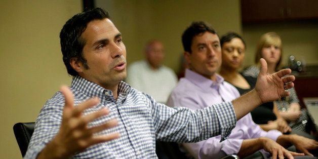 Independent U.S. Senate candidate Greg Orman talks to workers at a healthcare company, Wednesday, Sept. 10, 2014, in Overland Park, Kan. Orman is campaiging to unseat veteran Republican Sen. Pat Roberts. (AP Photo/Charlie Riedel)